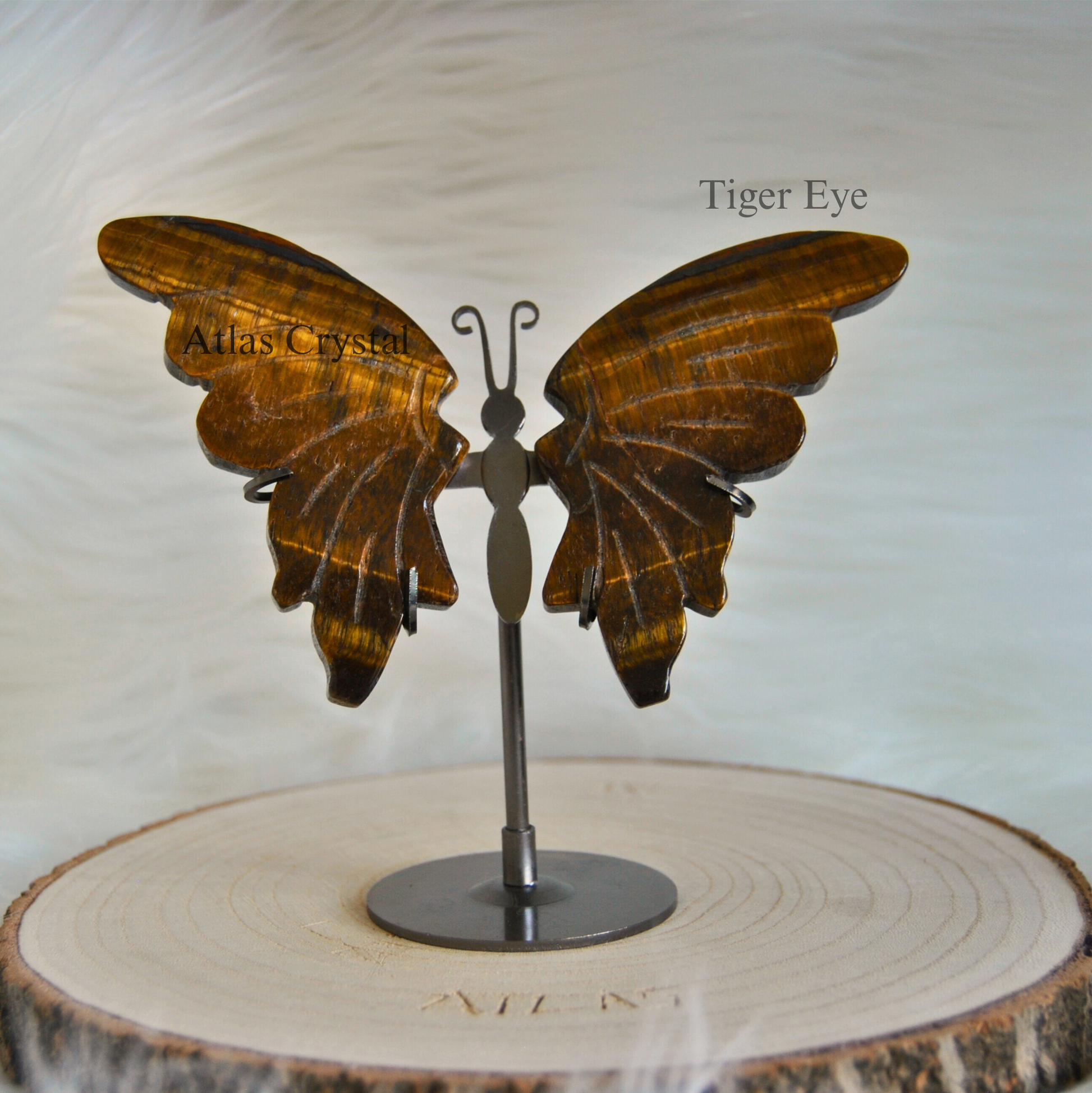 Expertly hand-carved from genuine Tiger Eye stone, this Butterfly Wings Set with matching stand showcases the stone's distinctive golden-brown bands and chatoyant luster. Beyond its striking aesthetic appeal, Tiger Eye is valued for promoting courage, mental clarity, and grounding energy. The butterfly design symbolizes transformation and spiritual growth, making this piece both a powerful energetic tool and an elegant decorative accent for any space. The included display stand enhances its presentation as 